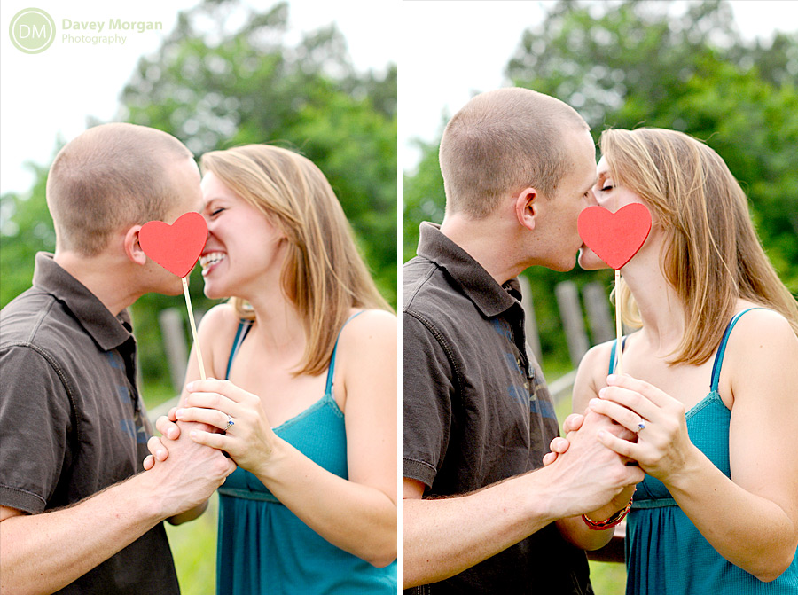 Couple kissing behind photo booth hearts | Davey Morgan Photography