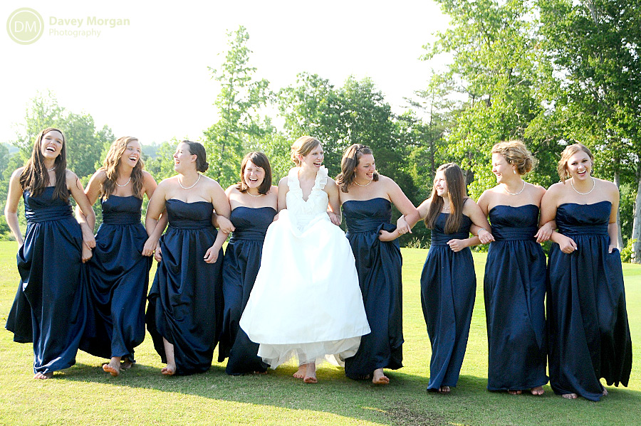 Bride and bridesmaids walking with arms linked picture | Davey Morgan Photography