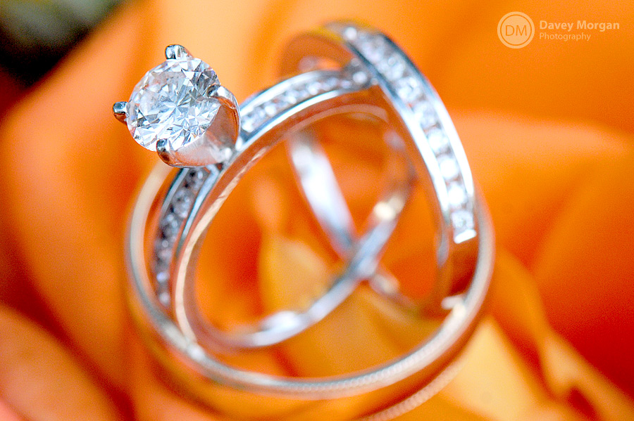 Wedding and engagement rings on clemson orange flowers | Davey Morgan Photography