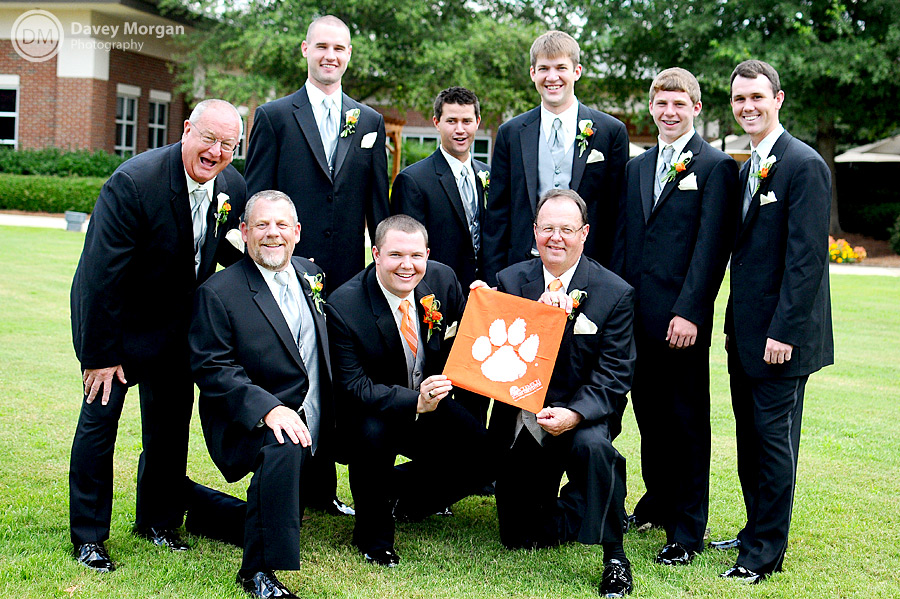 Groom and Groomsmen holding a Clemson Flag with tiger paw  | Davey Morgan Photography