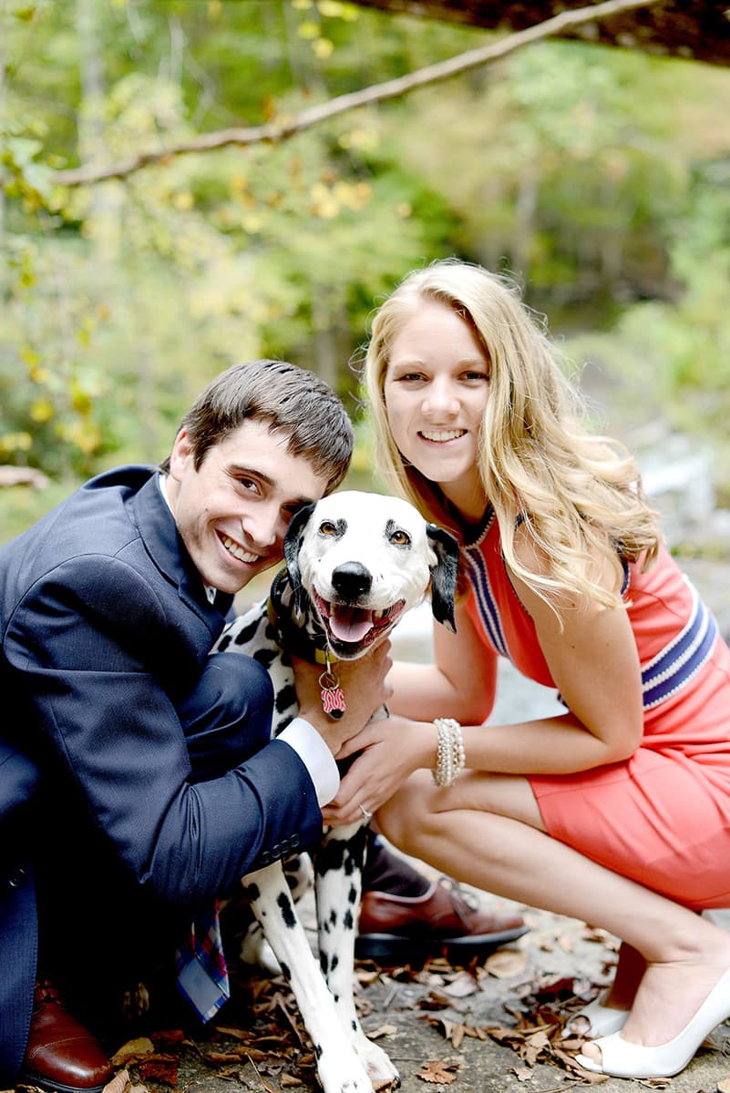 Engagement pictures with a dog by a waterfall