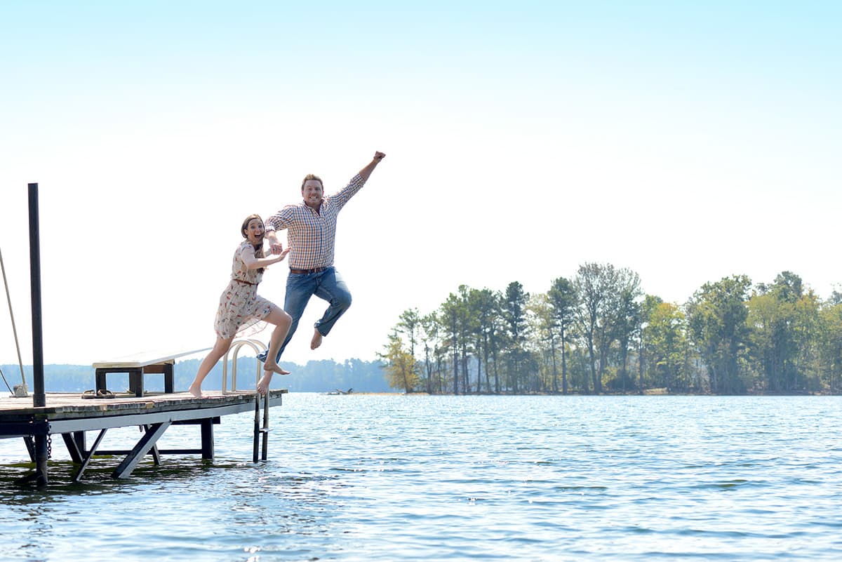 Jumping into water from a dock engagement pictures in Columbia, SC