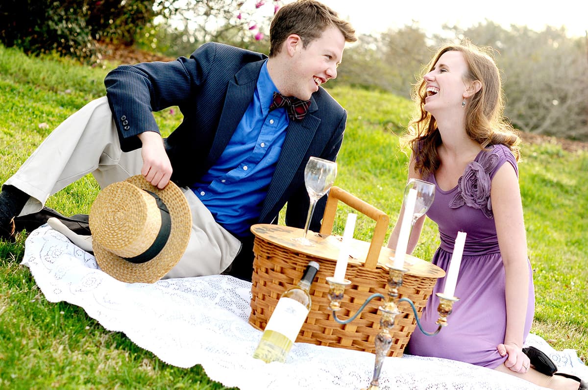 Clemson, SC engagement pictures with a picnic basket and wine with a vintage theme